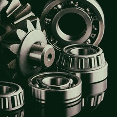 Gears, bearings and differential stars lie on the table close-up