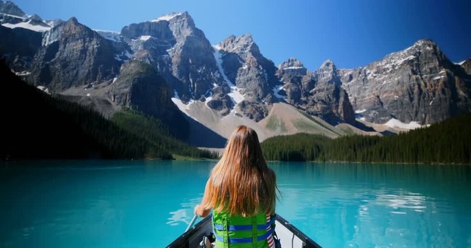Woman rowing a boat in river at countryside 4k