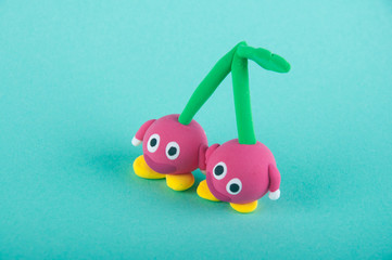 Funny fruits. Two red cherries on blue background