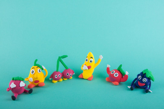 Six cute clay figures of fruits, berries, vegetables on blue background - Powered by Adobe