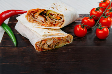 Shawarma sandwich - fresh roll of thin lavash (pita bread) filled with grilled meat, mushrooms,...