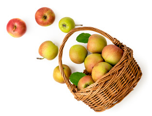 Ripe apples spilled out of the basket on a white background. The view from top.