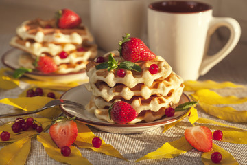 Waffles for breakfast, decorated with autumn leaves, berries