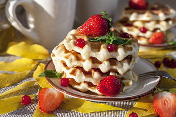 Waffles for breakfast, decorated with autumn leaves, berries