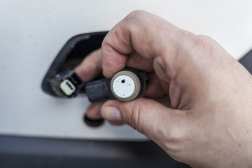 car mechanic changes the parking sensor on the car, the sensor malfunction of parking sensors