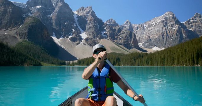 Man rowing a boat in river at countryside 4k