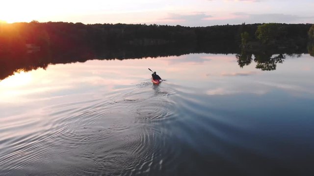 Man on kayak and sunset