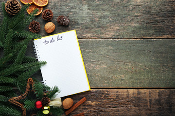 To do list in notepad with walnuts and cinnamon on wooden table
