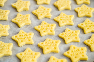 Christmas baking. Making gingerbread biscuits. Cookie star shape on kitchen counter.