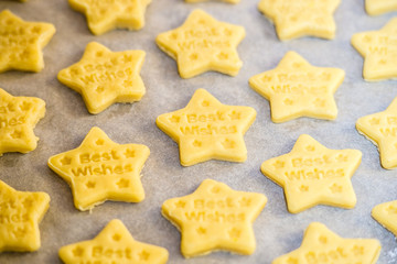 Christmas baking. Making gingerbread biscuits. Cookie star shape on kitchen counter.