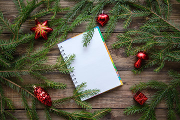 New Year picture with Christmas tree branches and a notebook
