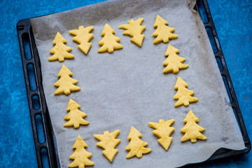 Christmas baking. Making gingerbread biscuits. Cookie star shape on kitchen counter.