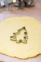 Christmas baking. Making gingerbread biscuits. Cookie star shape on kitchen counter.