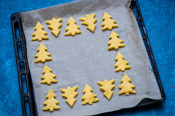 Christmas baking. Making gingerbread biscuits. Cookie star shape on kitchen counter.
