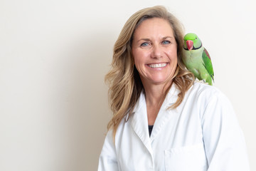 Friendly Female Veterinarian With Bird on Shoulder
