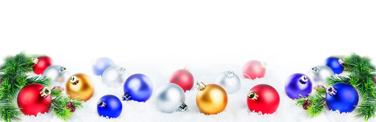 Fototapeta na wymiar Christmas colored balls on snow isolated background
