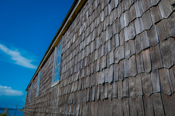 Close up of wooden exterior facade with window of church of Vilupulli, is a catholic temple in the locality of Vilupulli, in Chonchi, Chilo , south of Chile
