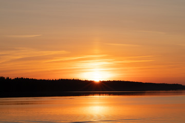 Beautiful Scenic Landscape. Orange Sunset With Ray Of Sun Behind Forest Over River.