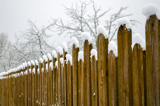 Wooden Fence From Picket Fence In Winter With Snow