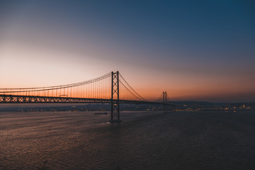 Fototapeta na wymiar Sunset over the '25 of April' Bridge in Lisbon, Portugal.