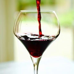 elegant glass of wine with red wine to be pored intuit with a splash