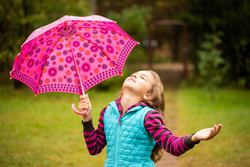 Beautiful Charming Russian Little Girl With Eyes Closed Hold In Her Hand Colorful Patterned Umbrella Walking, Enjoying Autumn Nature In Park Close Up.
