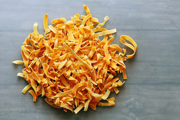 Orange italian pasta on a blue glass background