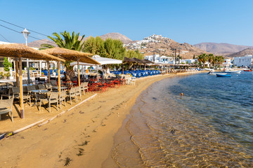 Sandy beach and greek taverns in Livadi town. Serifos island, Greece - obrazy, fototapety, plakaty