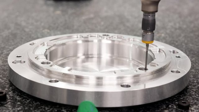Close Up Of Precision Measuring Machine Checking Component In Engineering Plant