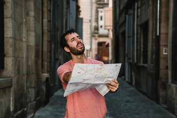 .Young tourist walking the streets of Bordeaux, in France. Using a map because it is lost in the city. Travel Photography. Lifestyle.