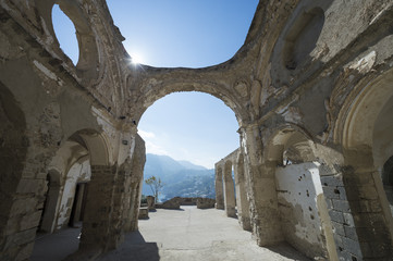 Scenic view of ancient Roman ruins arch architecture under bright blue Mediterranean sky