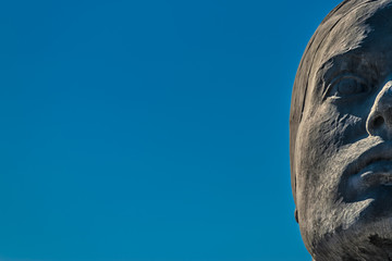 Detail of a sculpture in a roundabout in Coslada, showing half of a woman's face.