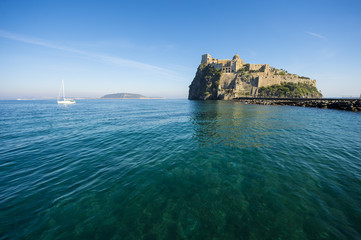 Scenic morning view of the dramatic Aragonese Castle looming from its ancient mountaintop perch above the Mediterranean island of Ischia, Italy