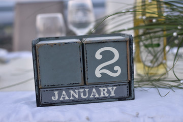 Wood blocks in box with date, day and month 2 January. Wooden blocks calendar