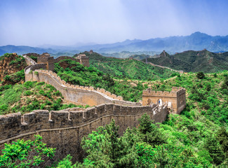 Fototapeta premium The Great Wall Jinshanling section with green trees in a sunny day, Beijing, China