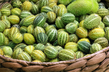 small decorative cucumbers in a wicker basket