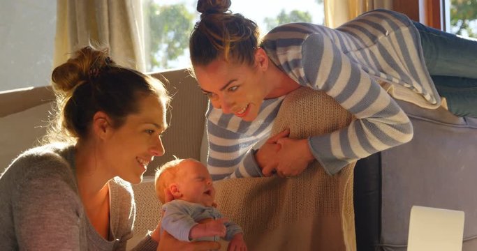 Lesbian couple playing with their baby boy
