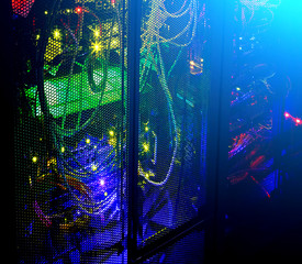 Data center in the night. Dark room with light from telecommunication lights.