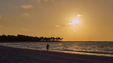 Woman on beach at sunrise 121