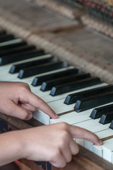Fototapeta na wymiar Little girl playing on the piano