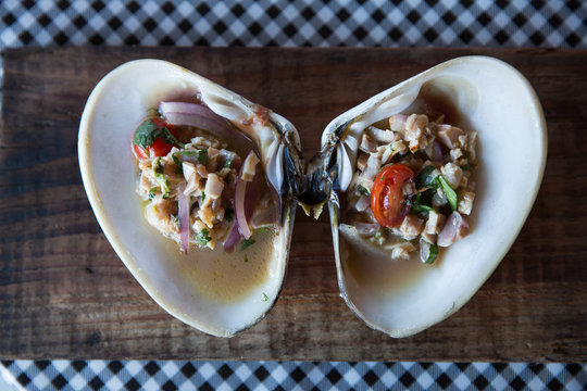 Cooked and chopped clam with onions, tomatos, cilantor and lemon juice.