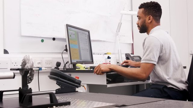 Male Engineer Uses CMM Coordinate Measuring Machine In Factory