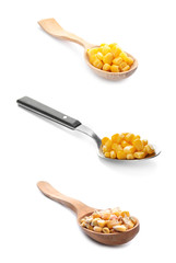 Set of spoons with sweet corn kernels on white background