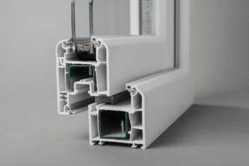 Sample of modern window profile on grey background, closeup