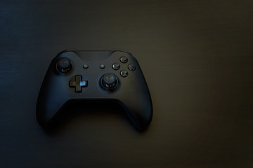 Black joystick gamepad, game console on black background. Computer gaming competition videogame control confrontation concept © Юлия Завалишина
