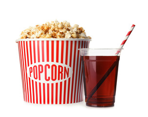Bucket with delicious popcorn and plastic cup of cola on white background