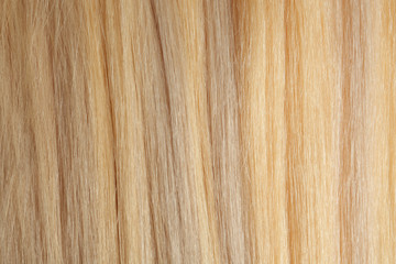 Texture of healthy blond hair as background, closeup