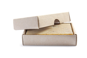 Hand made soap bar in cardboard package on white background
