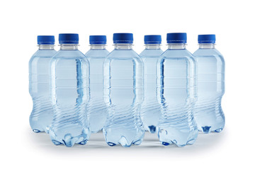Collection of plastic bottles with water on white background