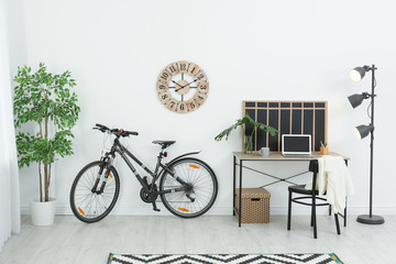 New bicycle near wall in stylish room interior